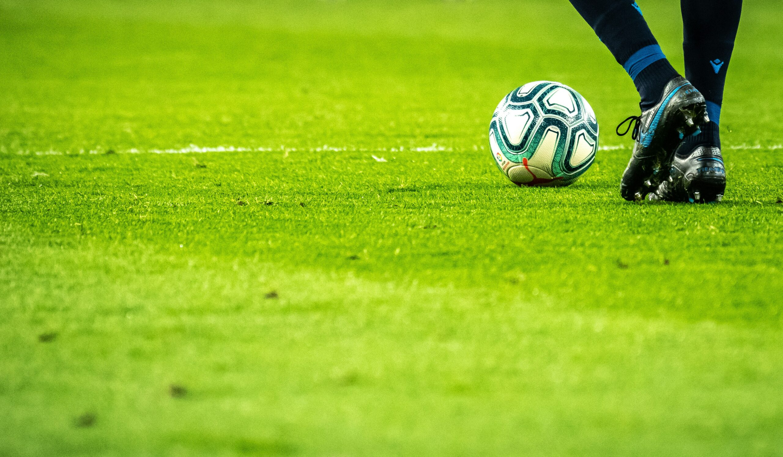 Player stepping to a ball on the pitch