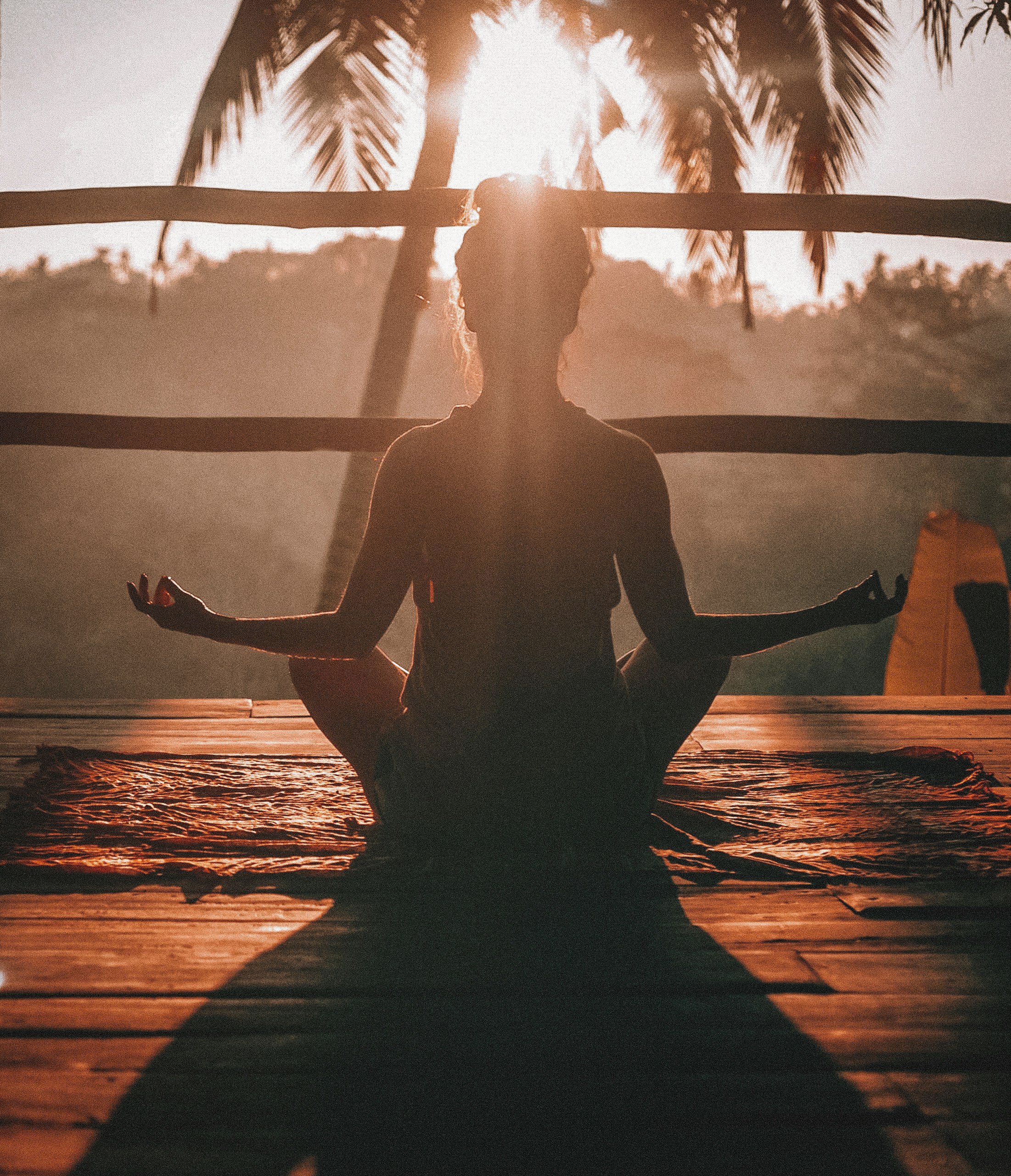 Person sitting still at sunrise